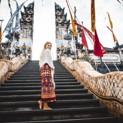 A woman at ancient gates in Pura Lempuyang ,Bali, Indonesia - Travel blogger exploring Bali landmarks